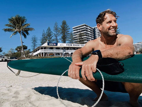 Branchy, founder of Summer vibes, on the beach at Rainbow Bay
