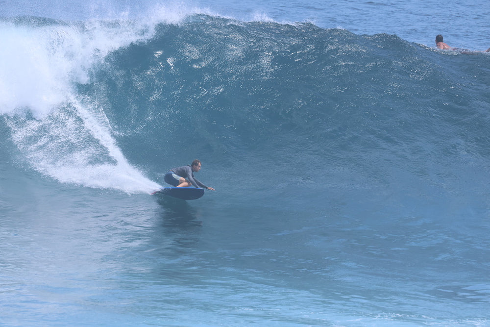 Surfer making a bottom turn on a blue Summer vibes Discus