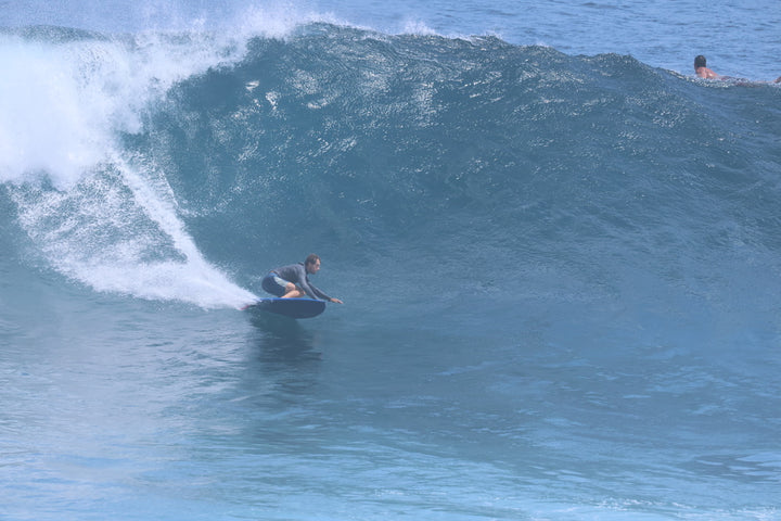 Surfer making a bottom turn on a blue Summer vibes Discus