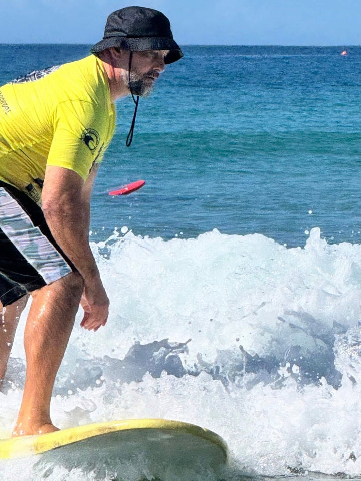 Riding a yellow Summer vibes Stable Table softboard in the whitewash